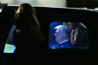 Presidente Donald Trump sentado na limusine presidencial 'The Beast'